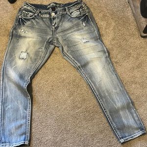 Stone washed distressed and embellished jeans
